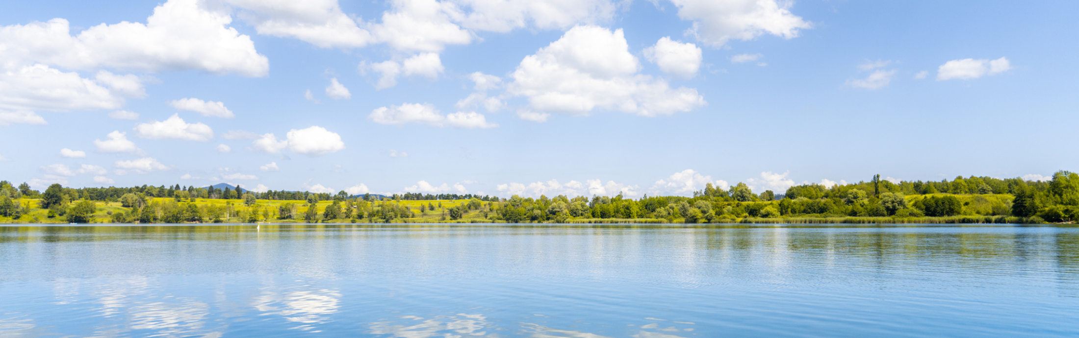Scenic view of clouds reflecting in lake.