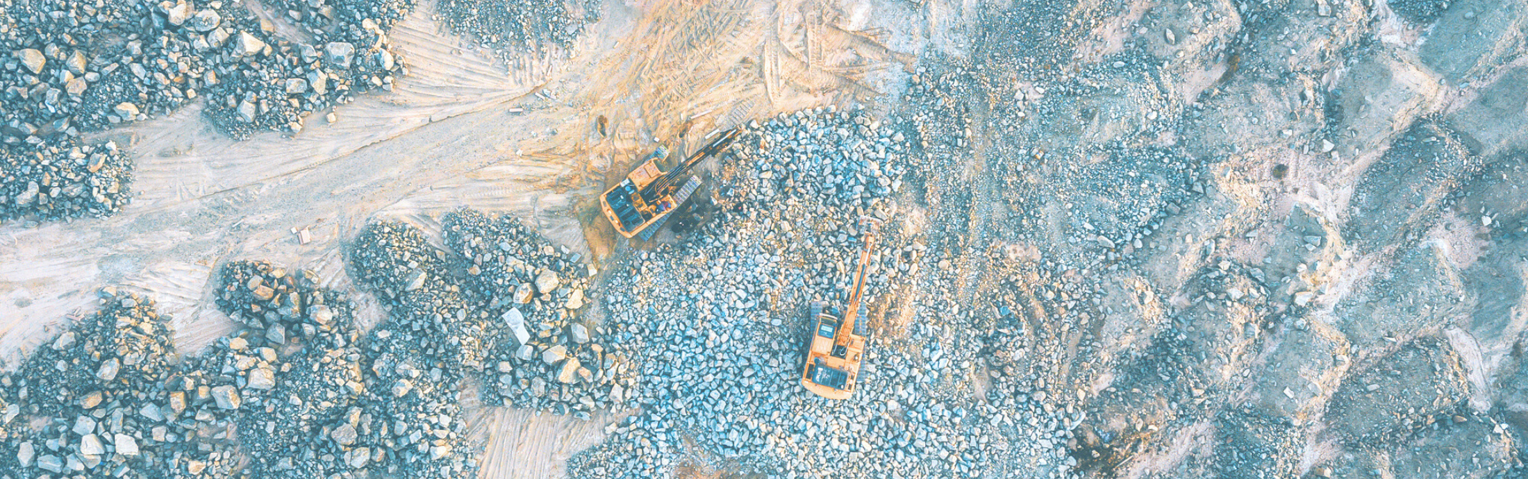 An aerial view of an open-pit mine and machinery.