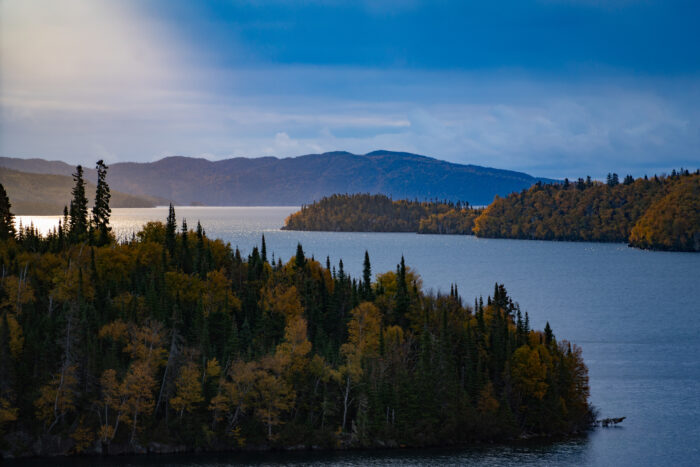 A scenic view of a lake and surrounding trees.